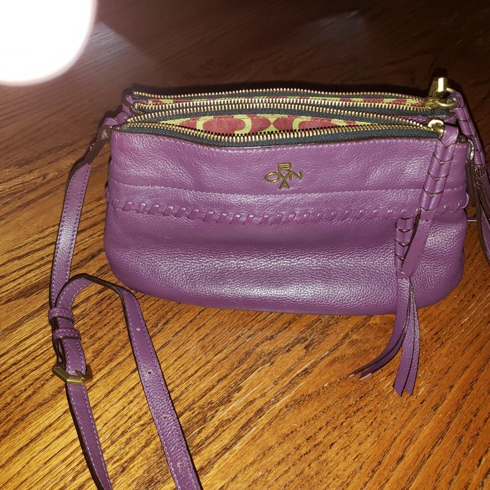 Beautiful dark plum Oryany pebble leather purse.